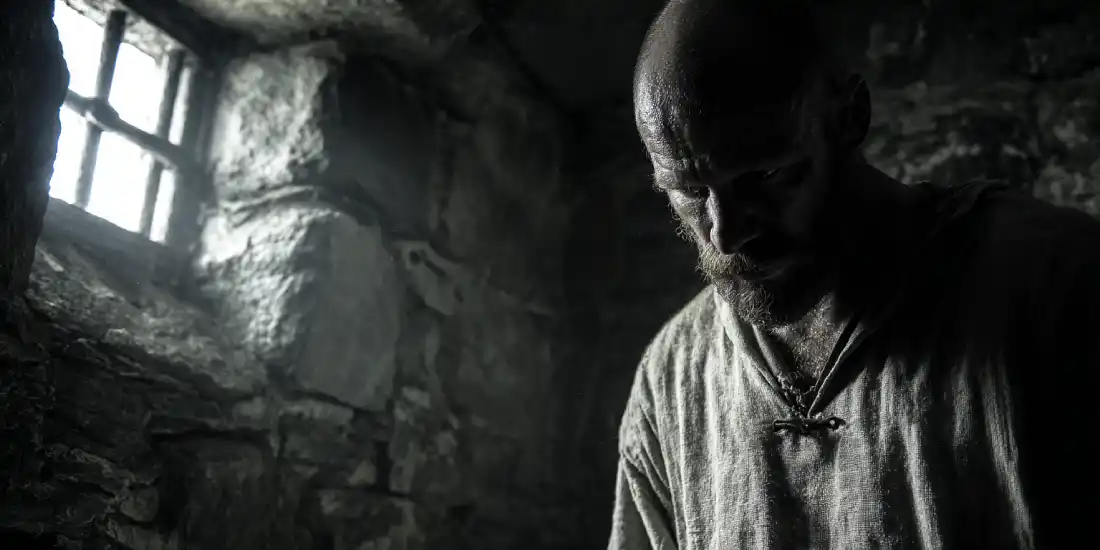 Man standing in prison cell representing struggle with Christian identity and lack of freedom